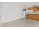 A kitchen includes wooden cabinets, a fridge, and a microwave at 10227 Parsons St, Tampa, FL 33615