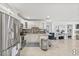 Bright kitchen featuring stainless steel appliances, white cabinetry, and tile floors at 10227 Parsons St, Tampa, FL 33615