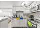 Updated kitchen with modern appliances and granite countertops, open to living area at 10227 Parsons St, Tampa, FL 33615