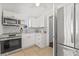 Well-lit kitchen featuring white cabinets, modern appliances, and beautiful backsplash at 10227 Parsons St, Tampa, FL 33615