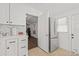 Open-concept kitchen featuring white cabinets and stainless-steel appliances at 10227 Parsons St, Tampa, FL 33615
