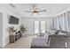 Living room featuring tile floors, a ceiling fan and access to the outside patio at 10227 Parsons St, Tampa, FL 33615