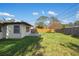 Large fenced backyard with green grass, perfect for outdoor activities and relaxation at 1073 Kenwood Dr, Dunedin, FL 34698