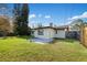 Expansive backyard featuring green grass and partial fencing, perfect for outdoor activities at 1073 Kenwood Dr, Dunedin, FL 34698