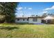 A spacious backyard with well-maintained lawn offers ample space for recreation at 1073 Kenwood Dr, Dunedin, FL 34698