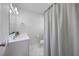 Clean bathroom featuring a vanity with a modern sink, marble floors, and a shower curtain at 1073 Kenwood Dr, Dunedin, FL 34698