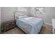 Bright bedroom with a decorative headboard, wood-style flooring, and natural light at 1073 Kenwood Dr, Dunedin, FL 34698