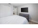 Comfortable bedroom showcasing a closet, a TV, and contemporary decor at 1073 Kenwood Dr, Dunedin, FL 34698