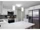 Kitchen features stainless appliances, stylish pendant lighting, and white countertops at 1073 Kenwood Dr, Dunedin, FL 34698