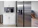 Bright kitchen features stainless steel refrigerator and modern white cabinets at 1073 Kenwood Dr, Dunedin, FL 34698