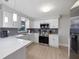 Bright kitchen features modern appliances, white cabinets, and elegant countertops at 1073 Kenwood Dr, Dunedin, FL 34698