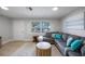 Inviting living room with a large sectional sofa and elegant wooden accents at 1073 Kenwood Dr, Dunedin, FL 34698