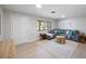 Bright living room featuring a comfortable gray sectional and stylish decor at 1073 Kenwood Dr, Dunedin, FL 34698