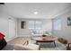 Bright living room with light wood floors, white walls, and ample natural light from the large window at 1073 Kenwood Dr, Dunedin, FL 34698