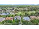 Expansive aerial view showcasing the home's location on a golf course with water views and lush landscaping at 18109 Kara Ct, Tampa, FL 33647