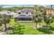 Aerial view of property featuring solar panels, lush landscaping, and a screened-in patio at 18109 Kara Ct, Tampa, FL 33647