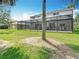 Backyard features a screened-in patio and lush green lawn at 18109 Kara Ct, Tampa, FL 33647