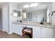 Bright bathroom featuring double vanities, a granite countertop, modern fixtures, and a separate soaking tub and shower at 18109 Kara Ct, Tampa, FL 33647
