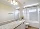 Light and bright bathroom featuring a shower-tub combo and a granite countertop at 18109 Kara Ct, Tampa, FL 33647