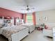 Bright bedroom with twin beds, pink accent wall, and built-in bookshelves at 18109 Kara Ct, Tampa, FL 33647