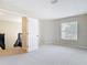 Bright, carpeted bedroom features a large window, a ceiling fan, and entry to the stairs at 18109 Kara Ct, Tampa, FL 33647