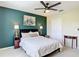 Cozy bedroom with a queen bed, green accent wall and warm lighting at 18109 Kara Ct, Tampa, FL 33647