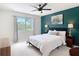 Bedroom with a large window, green accent wall and neutral carpet at 18109 Kara Ct, Tampa, FL 33647