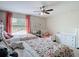 Shared bedroom with twin beds, soft pink curtains, and ample dresser storage at 18109 Kara Ct, Tampa, FL 33647