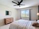 Bright bedroom featuring a dresser and window with natural light and outdoor view at 18109 Kara Ct, Tampa, FL 33647
