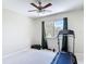 Neutral bedroom with a ceiling fan, a window with views, and a treadmill at 18109 Kara Ct, Tampa, FL 33647