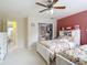 Shared bedroom with closet, twin beds, pink accent wall, and built-in storage at 18109 Kara Ct, Tampa, FL 33647