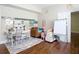 Bonus room with hardwood floors, a brown sofa, a large whiteboard, and plenty of decor at 18109 Kara Ct, Tampa, FL 33647