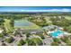 Aerial view of the community center, lake, pool, tennis courts, putting green and manicured landscaping at 18109 Kara Ct, Tampa, FL 33647