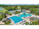 An aerial view of the community pool with ample lounge chairs and shaded areas surrounded by lush greenery at 18109 Kara Ct, Tampa, FL 33647