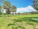 Scenic view of the community featuring a serene lake and well-maintained landscaping at 18109 Kara Ct, Tampa, FL 33647
