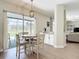 Dining area with backyard views, complemented by a stylish light fixture and access to the lanai at 18109 Kara Ct, Tampa, FL 33647