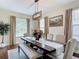 Charming dining room with a long wooden table, bench seating, and plenty of natural light at 18109 Kara Ct, Tampa, FL 33647