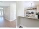 Open-concept entry with hardwood floors leading to the bright kitchen and dining areas at 18109 Kara Ct, Tampa, FL 33647