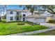 Charming two-story home with blue front door, lush lawn, and well-maintained landscaping at 18109 Kara Ct, Tampa, FL 33647