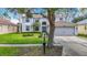 Charming two-story home with blue double door and well-maintained front yard landscaping at 18109 Kara Ct, Tampa, FL 33647