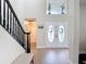 Welcoming foyer features staircase, decorative double doors, wooden floors, and natural light at 18109 Kara Ct, Tampa, FL 33647