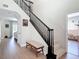 Spacious foyer with staircase, wooden floors, and views into the living room at 18109 Kara Ct, Tampa, FL 33647