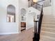 Foyer featuring a staircase with dark wood banister and a view into the adjacent living spaces at 18109 Kara Ct, Tampa, FL 33647