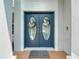 Close up of stylish double front doors with welcome mat on brick steps at 18109 Kara Ct, Tampa, FL 33647