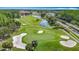Beautiful aerial view of a lush golf course with sand traps and a scenic water hazard at 18109 Kara Ct, Tampa, FL 33647