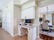 Functional built-in home office nook featuring upper and lower cabinets, a granite desktop, and natural light at 18109 Kara Ct, Tampa, FL 33647