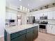 Spacious kitchen featuring an island with seating, stainless steel appliances, and stylish pendant lighting at 18109 Kara Ct, Tampa, FL 33647