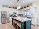 Open kitchen with center island, stainless steel appliances, and white subway tile backsplash at 18109 Kara Ct, Tampa, FL 33647