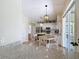 Open concept kitchen with central island, dining area, and view to the outdoor living space at 18109 Kara Ct, Tampa, FL 33647