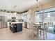 Open kitchen and dining area featuring an island with seating and a sliding glass door to the screened lanai at 18109 Kara Ct, Tampa, FL 33647